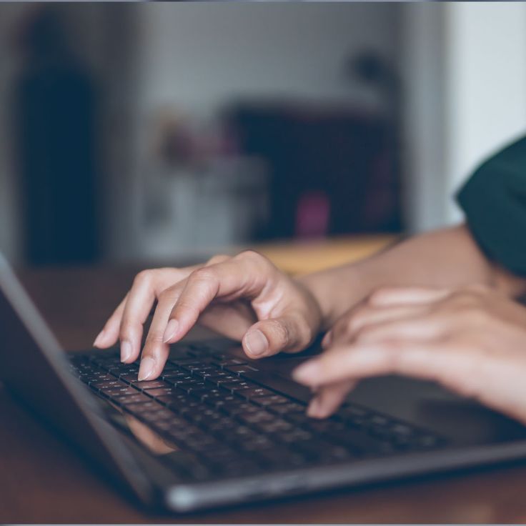 Hands typing on keyboard implementing metadata changes